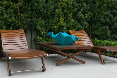 Chair and table against trees