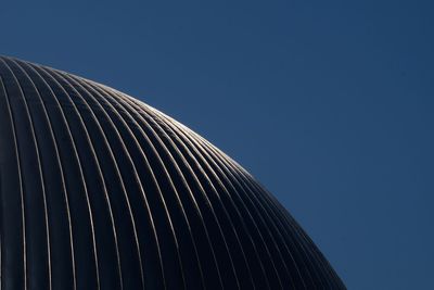 Low angle view of modern building against clear blue sky