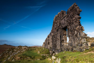 Low angle view of rock formations against sky