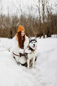 Portrait of dog on snow covered field