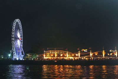 Illuminated ferris wheel at night