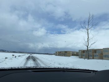 Snow covered road seen through car windshield