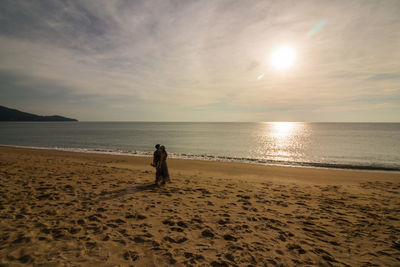 Scenic view of beach against sky during sunset