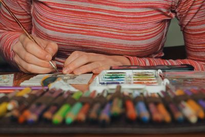 Midsection of woman painting easter bunny