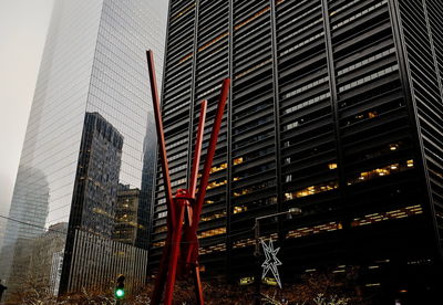 Low angle view of modern buildings against sky at night