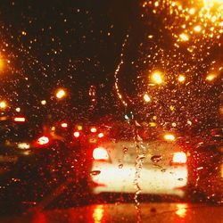 Close-up of raindrops on car windshield