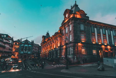 View of city street and buildings at dusk