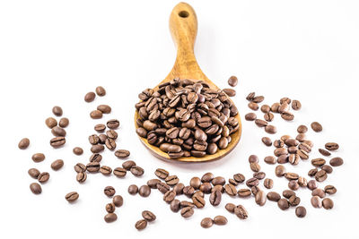 High angle view of coffee beans against white background