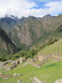 High angle view of green landscape against cloudy sky - machu picchu