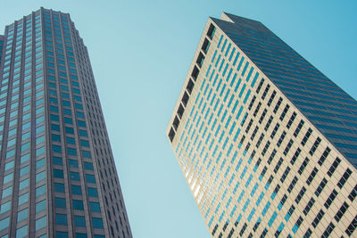 Low angle view of modern buildings against clear blue sky