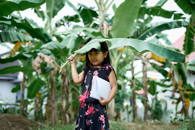 Full length of girl standing on leaves