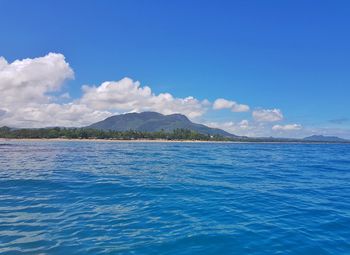 Scenic view of sea against blue sky