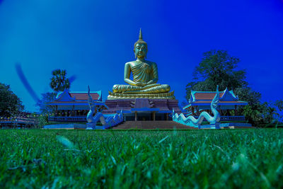 Low angle view of statue against blue sky