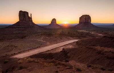 The sun setting over a desert landscape