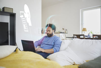 Man reading fake news on laptop