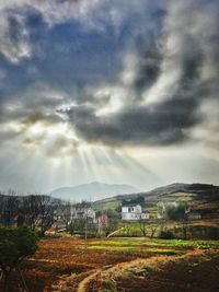 Scenic view of storm clouds over grass