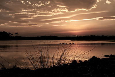 Scenic view of lake against sky during sunset