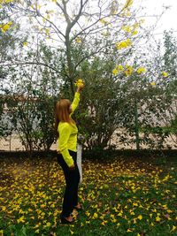 Full length of girl standing on grassy field in park