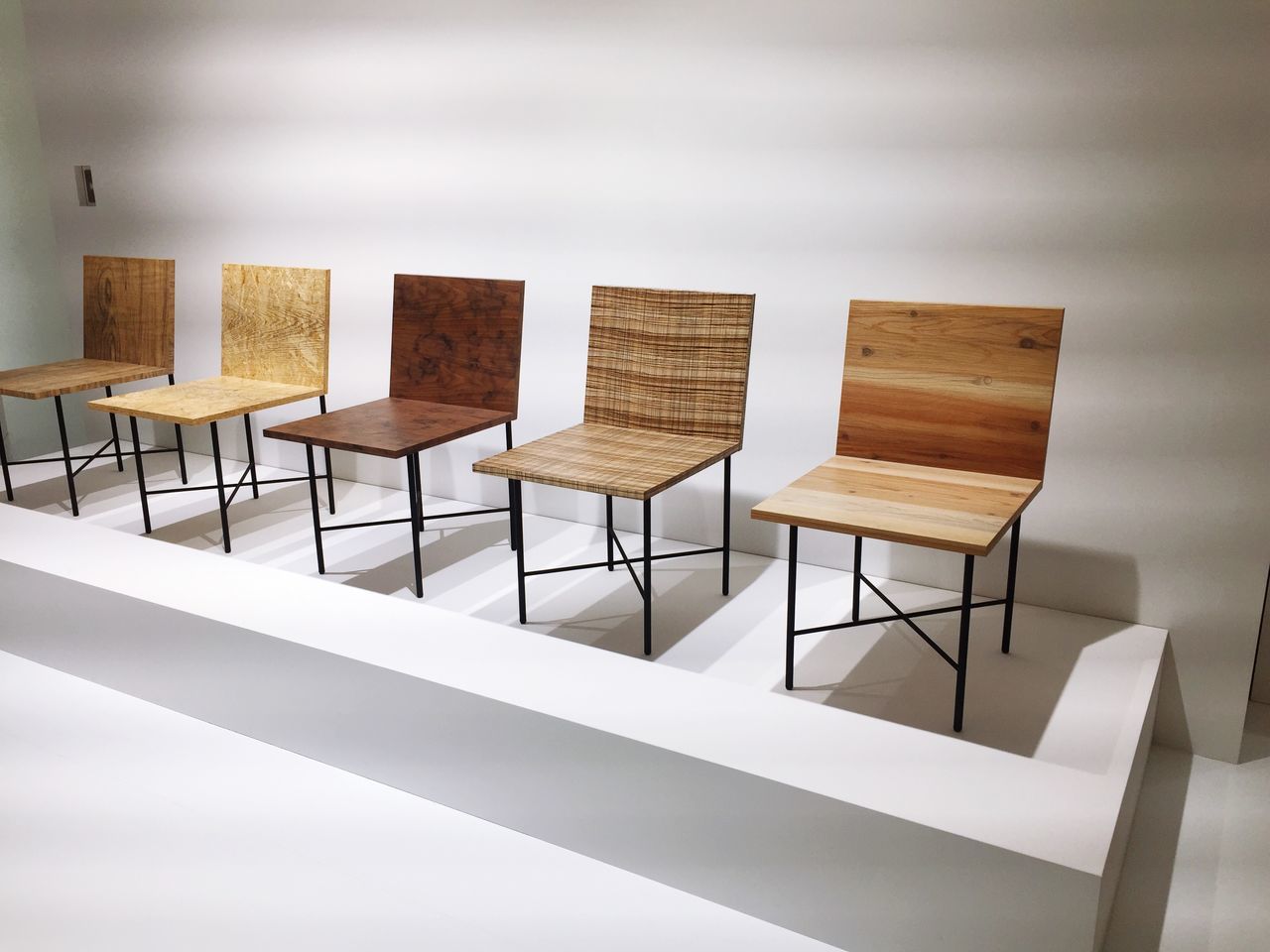 indoors, in a row, empty, absence, chair, arrangement, wood - material, side by side, table, repetition, shadow, no people, seat, large group of objects, day, wooden, order, still life, sunlight, stack