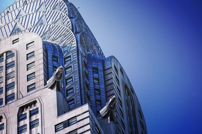 Low angle view of skyscraper against clear blue sky