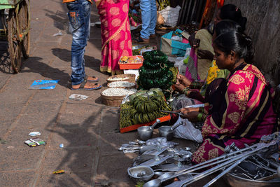 People sitting on street market