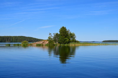 Scenic view of lake against blue sky