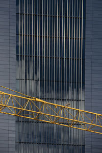 Metal railing of modern building and crane