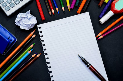 High angle view of school supplies on table