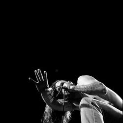 Close-up of hands over black background