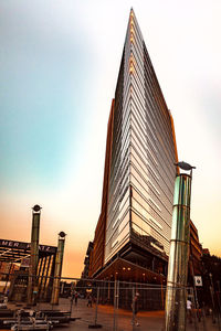 Low angle view of modern buildings against sky during sunset