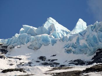 Snowcapped mountains against clear blue sky