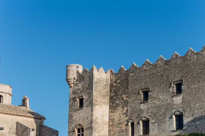 Low angle view of buildings against blue sky