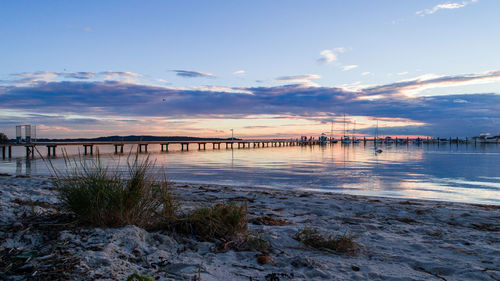 Scenic view of beach against sky during sunset