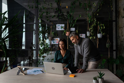 Beautiful businesswoman listening to professional advisor in her office