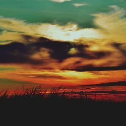 Scenic view of dramatic sky over field