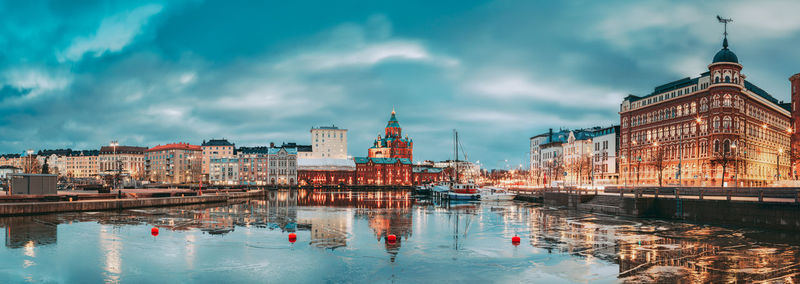 Reflection of buildings in city against sky