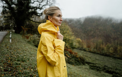 Portrait of young woman standing on field