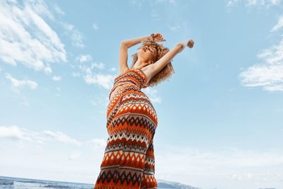 Rear view of woman standing against sky