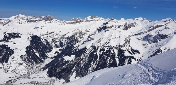 Scenic view of snowcapped mountains against sky