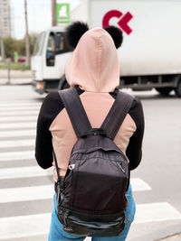 Rear view of man standing on footpath