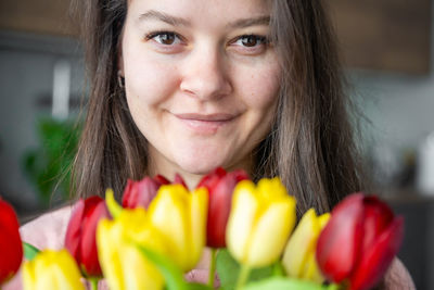 Close-up portrait of smiling young woman eating food