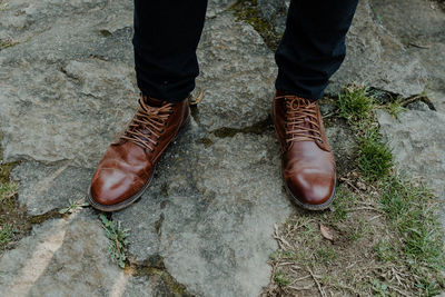 Low section of man standing on footpath