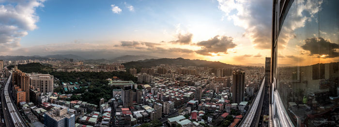 High angle view of cityscape against cloudy sky