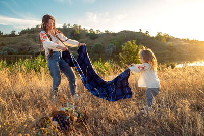 Global view, real life around the globe, local living. mom and daughter in national clothes and