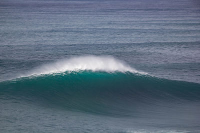 High angle view of waves breaking on sea