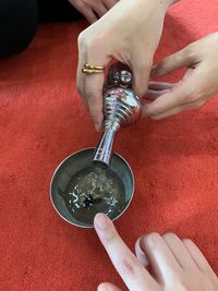 High angle view of woman hand holding cup