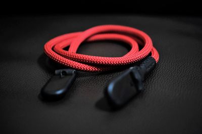 Close-up of red strap on black leather