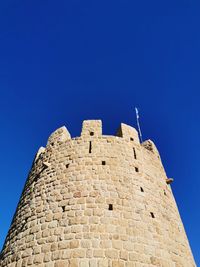 Low angle view of fort against blue sky