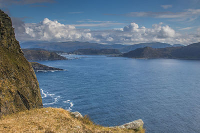 Scenic view of sea and mountains against sky