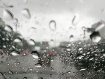 Full frame shot of wet glass window in rainy season